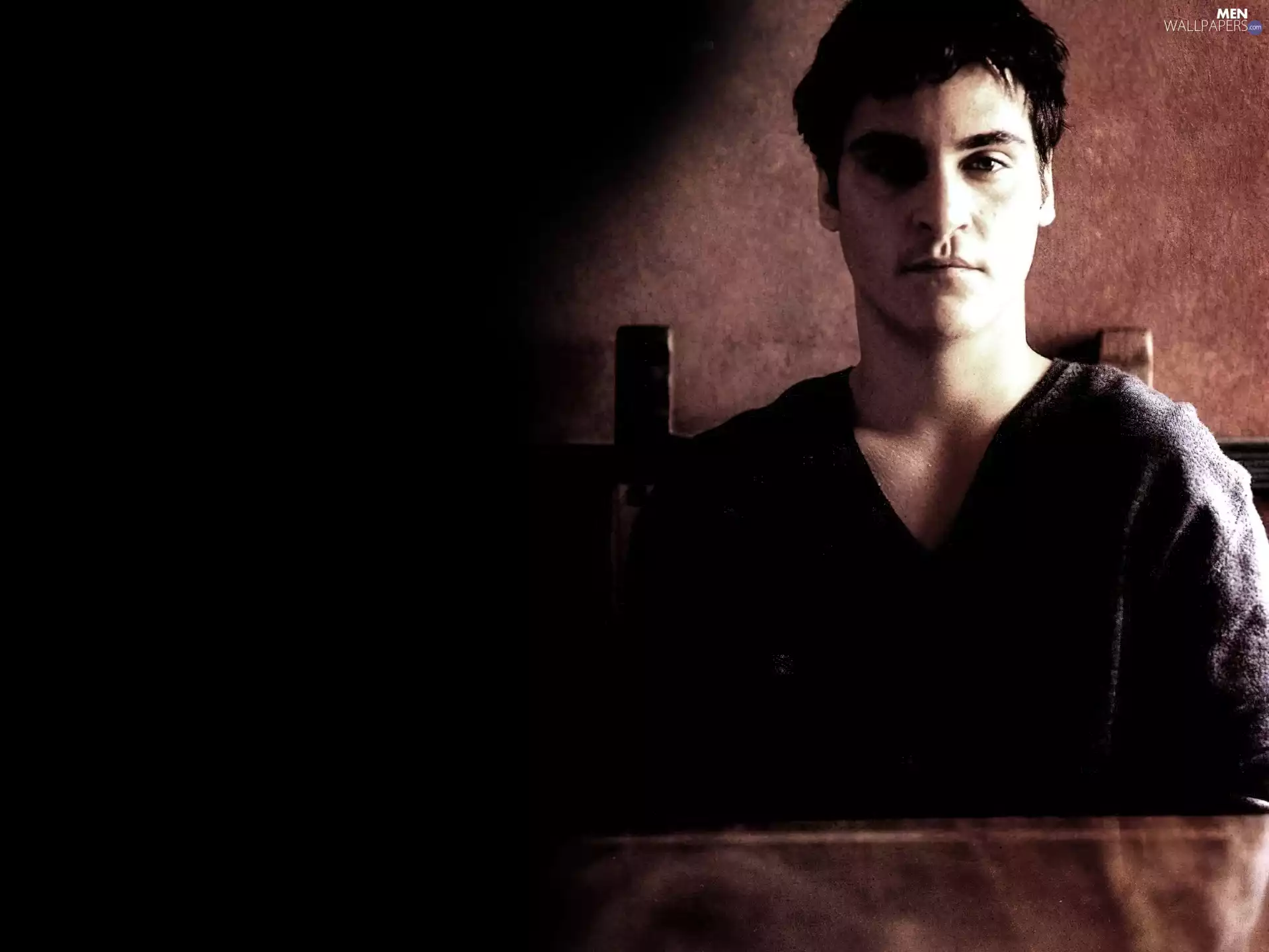 Joaquin Phoenix, black sweater